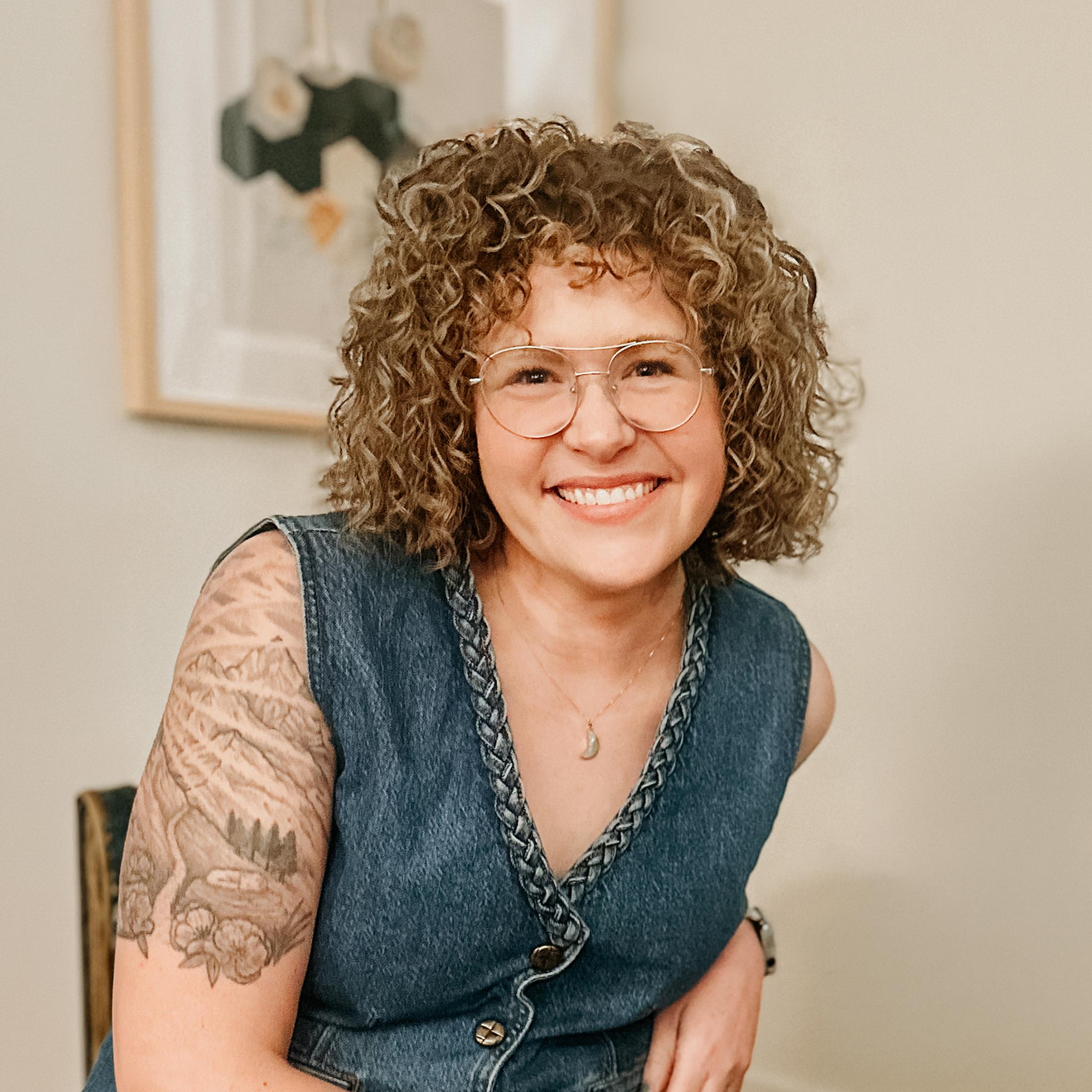 Portrait of Abby Howard smiling, seated indoors