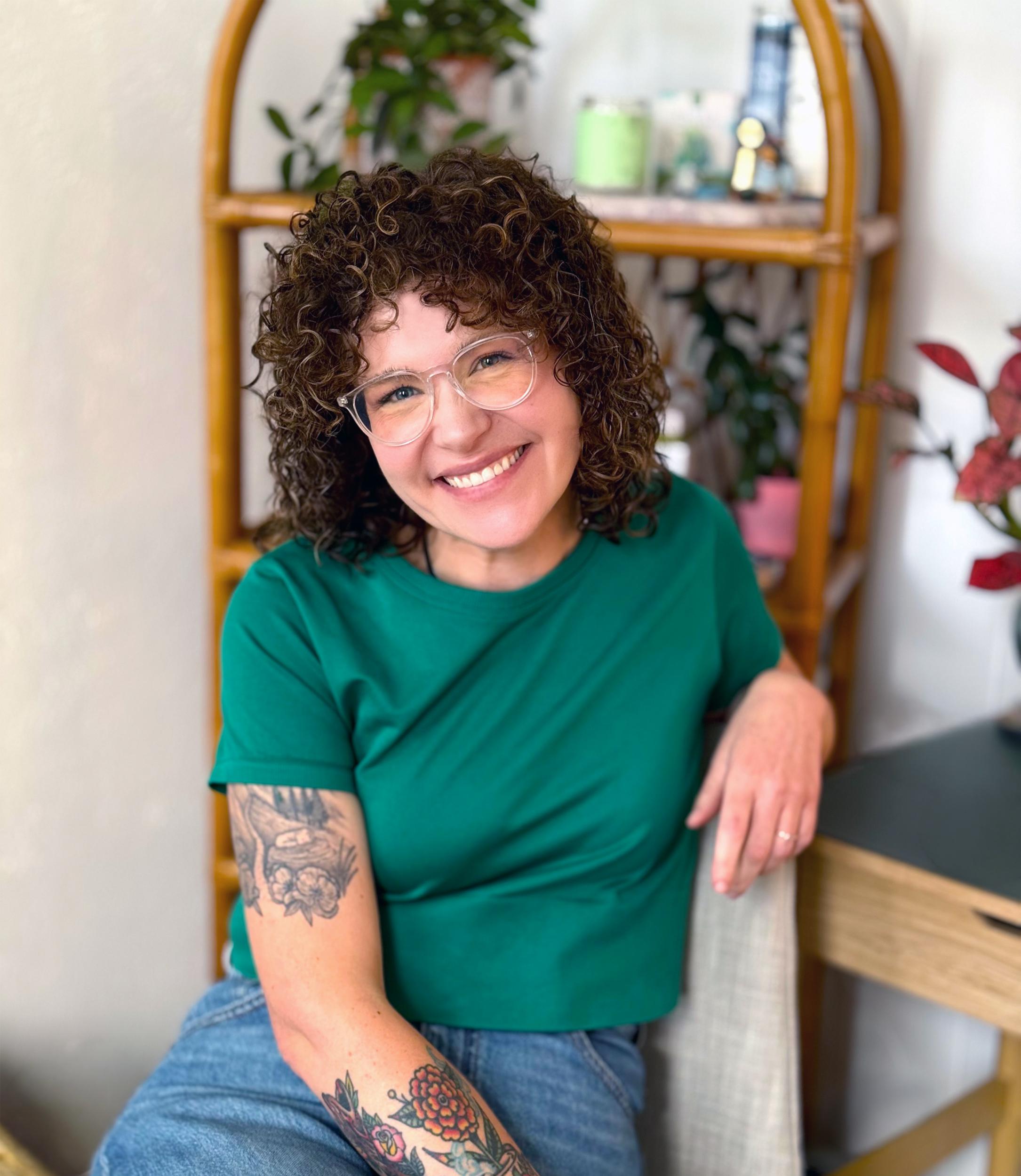Portrait of Abby Howard smiling, seated indoors