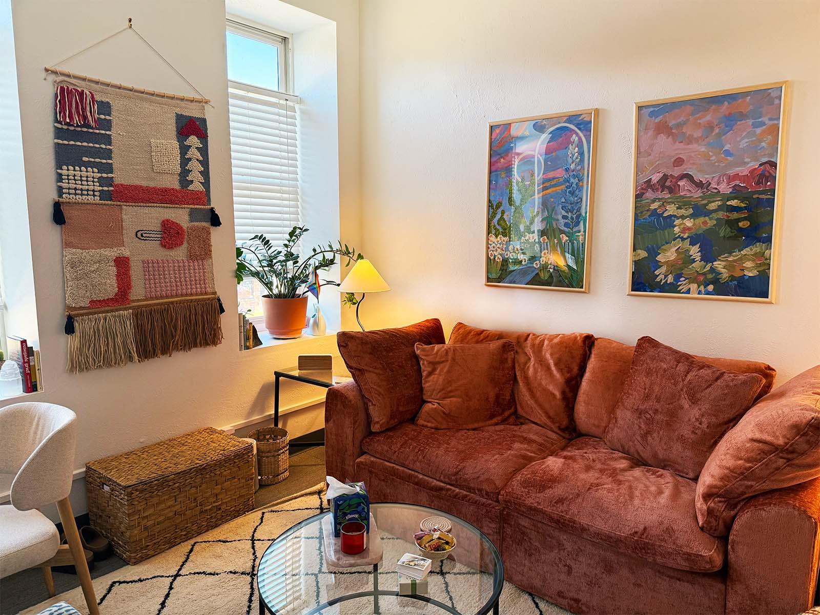 Abby Howard Counseling's office, a cozy seating area with art, plants, and a couch